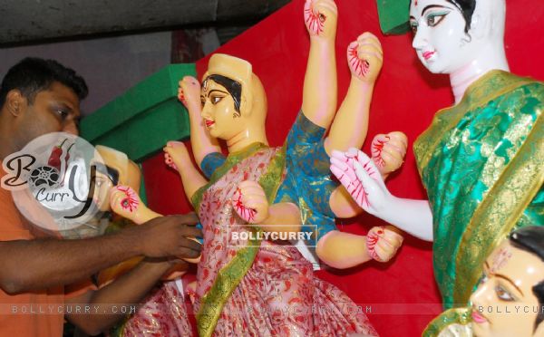 An Artist of Kumartuli finishing touch at a Durga idol made by Shola (Pith) for Overseas country in Kolkata on Wednesday 12th Aug 09