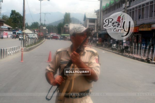 An armed security force personnel near the site of the gun fight with two militants in Srinagar