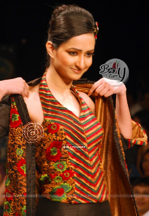 A model catwalks in an outfit design by Kaushik and Pallob during the Kolkata Fashion Week in Kolkata on 10th Sep 2009