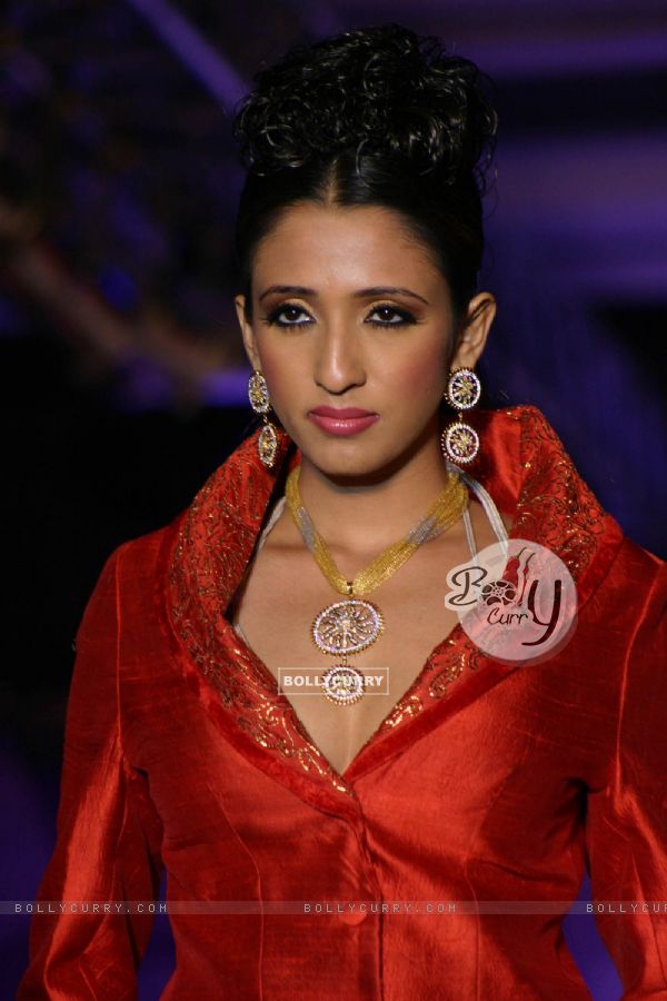 A model showcasing H G Jewelers gold jewelry collection made with enlightened swarovski elements at a fashion show, in New Delhi on Sunday