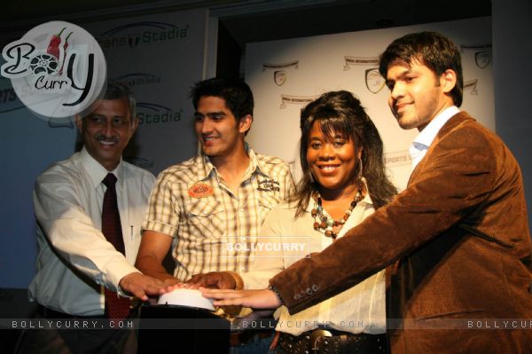 Boxer Vijender Singh signs a boxing glove during the press conference to announce India International Sports Summit in Mumbai on Wednesday,21 October 2009