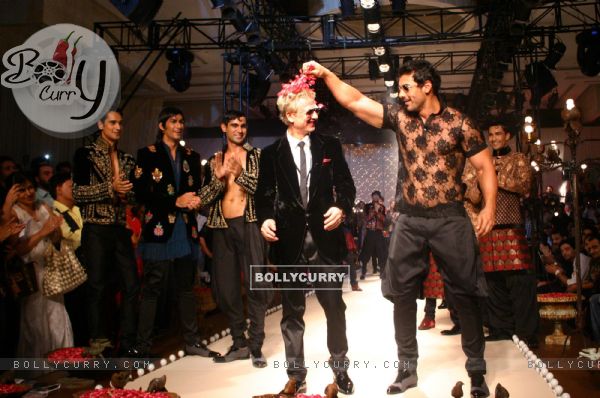 Designer Rohit Bal with Bollywood actor John Abraham  during his show  at the Ven Heusen India Mens Week, in New Delhi