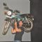 John Abraham holds up bike during the promotion of their film 'Force' in Mumbai