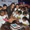 Sonakshi Sinha cuts a cake with the children at a special screeing of Rio 2