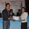 Sonu Sood giving certificate to student at MUNA event.