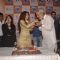 Soha Ali Khan feeding a piece of cake to a guest at the Launch of Saiffconnect Portal