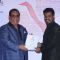 Satish Kaushik presents an award to a winner at the Closing Ceremony of 16th MAMI Film Festival