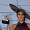 Jacqueline Fernandes holds up her momento at the Metro Motors Auto Hangar Race