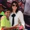 Amrita Raichand poses with a kid at the Special Christmas Treat for Underprivileged Children