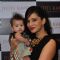 Jyoti Kapoor poses with a kid at her Jewellery Exhibition
