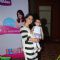 Kajol poses with a kid at Huggies Event