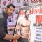 John Abraham signs his autograph at the Cover of Men's Health March Edition