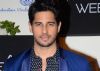 Why does Sidharth Malhotra want to visit a PSYCHIC?