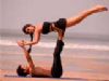 Bruna and Omar rehearsing some acro-yoga moves on the beach